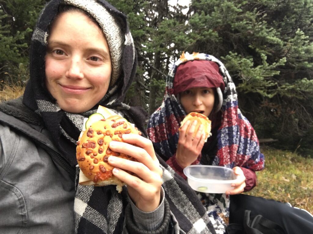 two girls eating sandwiches on mount riordan