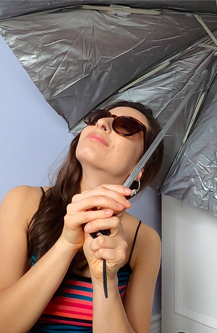 girl using umbrella and sun glasses