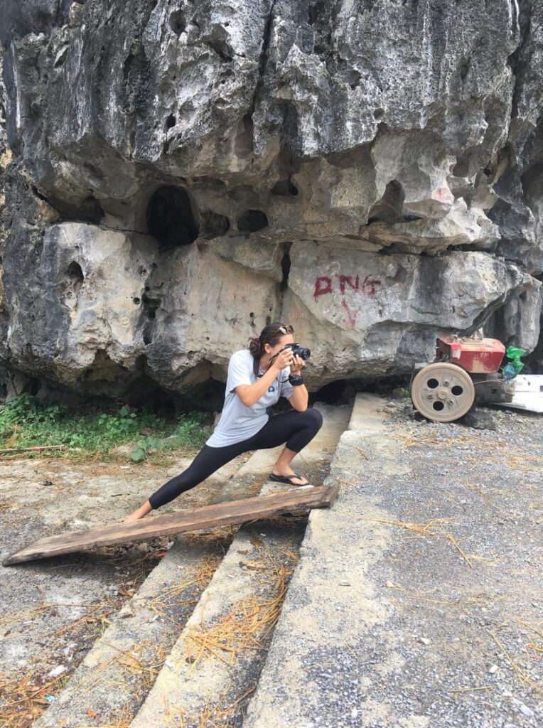 Dee lunging while taking photo in Tam Coc, Vietnam.